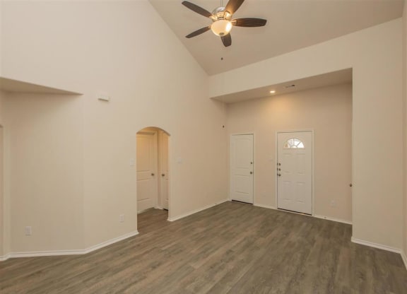 an empty living room with a ceiling fan at The Village at Granger Pines, Conroe Texas