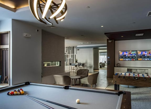 a game room with a pool table and a television