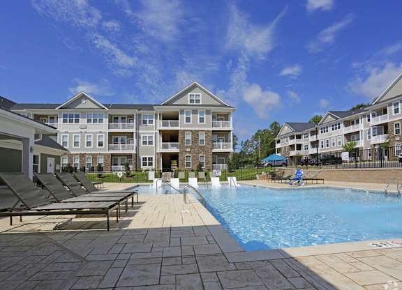 a swimming pool in front of an apartment building