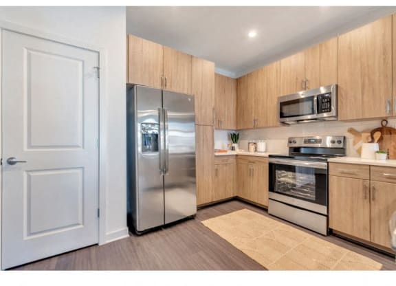 a kitchen with stainless steel appliances and a refrigerator