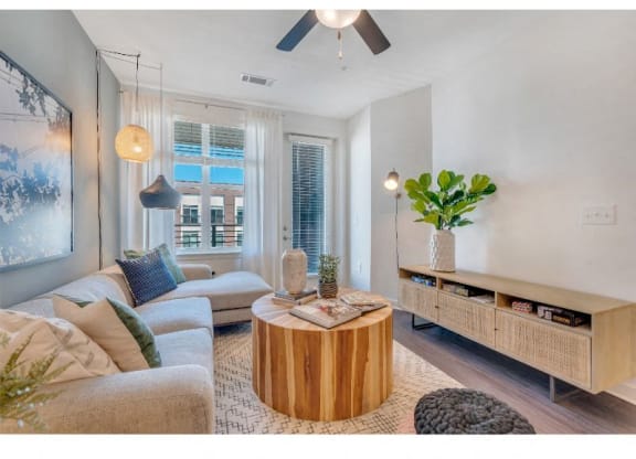a living room filled with furniture and a large window