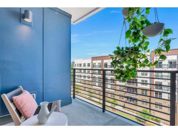 a balcony with a blue wall and a view of a city