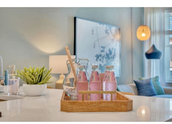 a tray of pink drinks on a counter in a living room