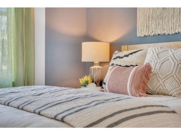 a bedroom with a bed and a lamp