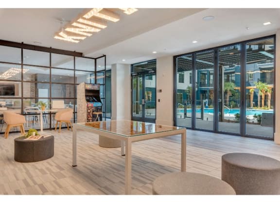 a lobby with a table and chairs and a pool