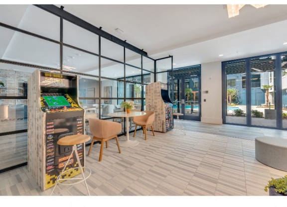 a game room with a foosball table and chairs