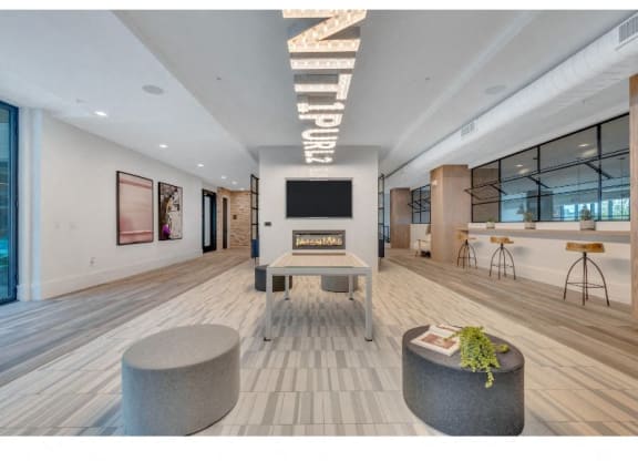 a large living room with a fireplace and a table