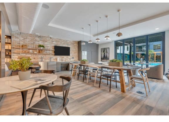 a restaurant with tables and chairs and a living room with a pool