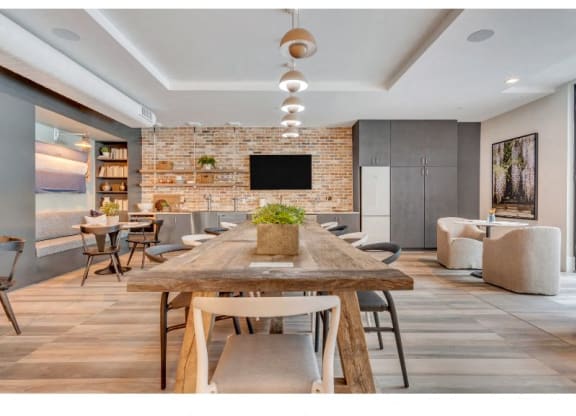 a large dining room with a wooden table and chairs