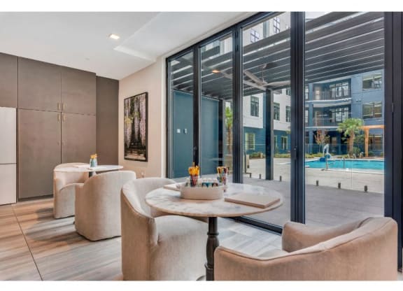 a living room with chairs and a table and a pool
