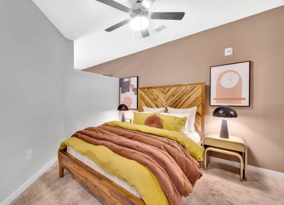 a bedroom with a bed and a ceiling fan