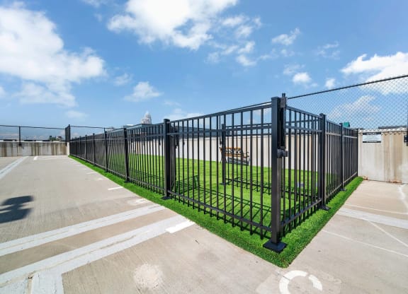 a fence with a field behind it in a parking lot