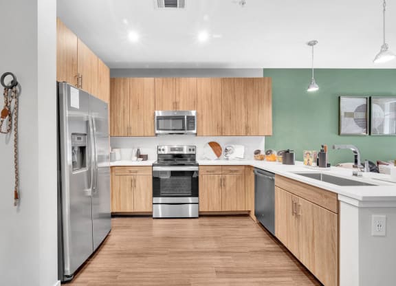 a kitchen with wooden cabinets and stainless steel appliances