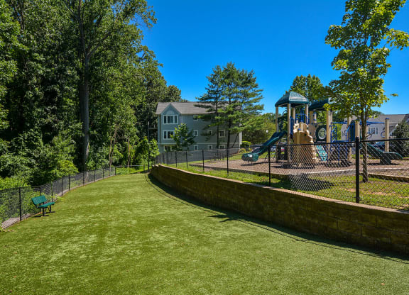 a yard with a playground and a swing set