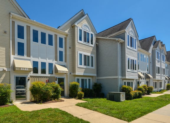 a row of houses with a sidewalk in front of them