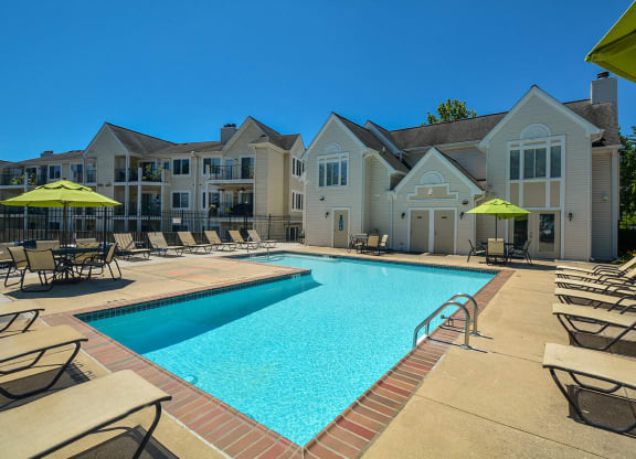 our apartments have a swimming pool with chairs and umbrellas