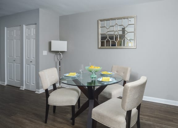 a dining room with a table and chairs and a window