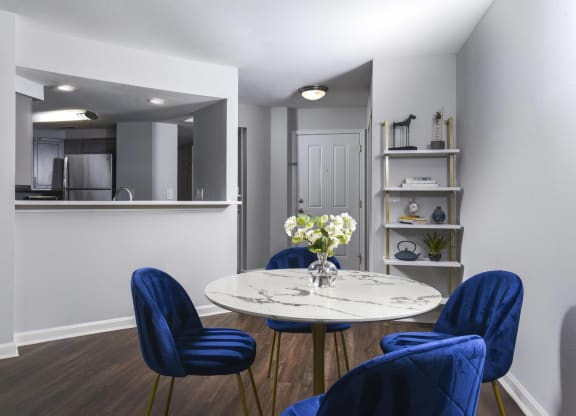 a dining room with a table and chairs and a kitchen