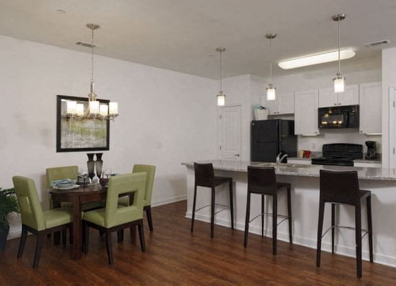 a kitchen and dining room with a table and chairs