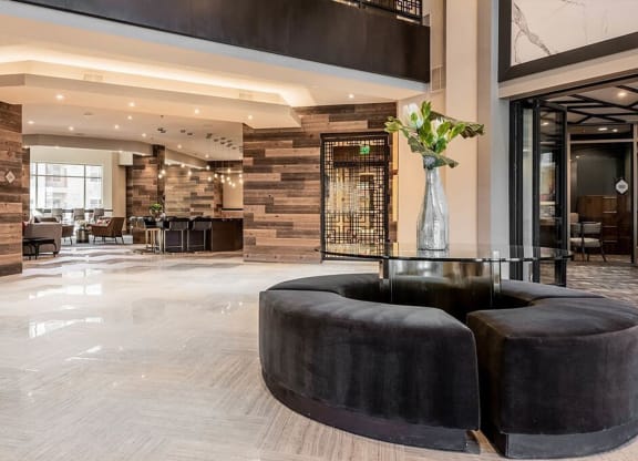 the lobby or reception area of a hotel with black furniture