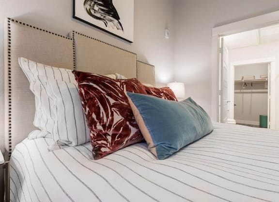 a bedroom with a large bed with pillows on it