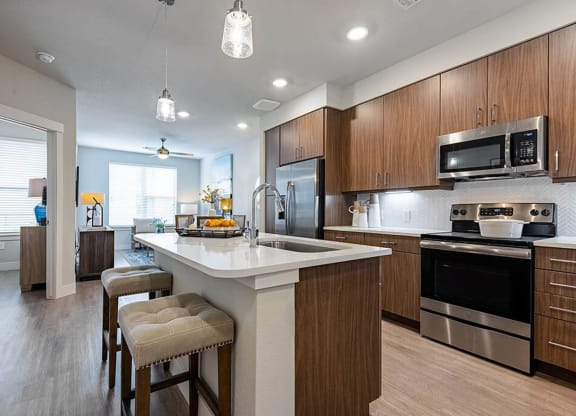 a kitchen with a large island with stools