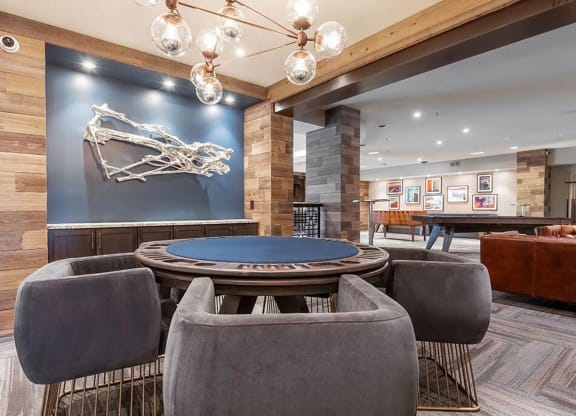 a poker table is in the center of a room with chairs