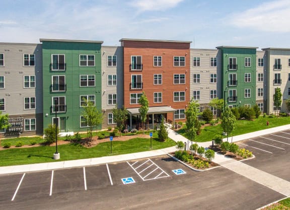 an aerial view of an apartment building in a parking lot