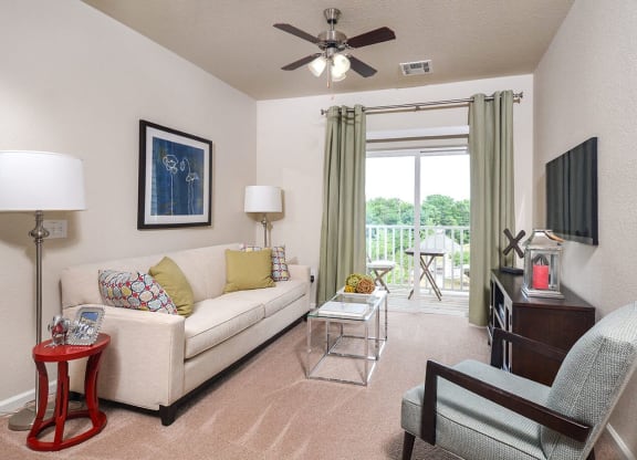 a living room with a couch and a ceiling fan