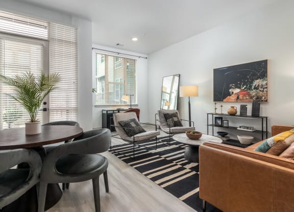 a living room with a table and chairs and a couch