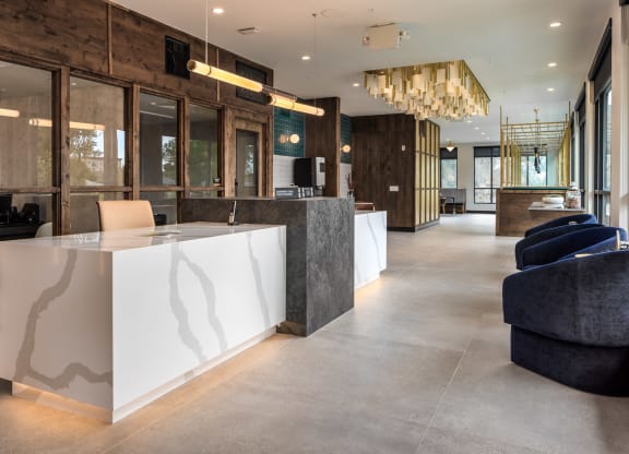 the lobby of a hotel with a reception desk and chairs