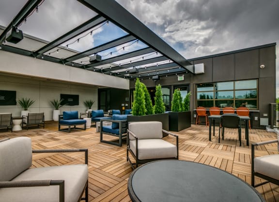 a patio with chairs and tables and a glass roof
