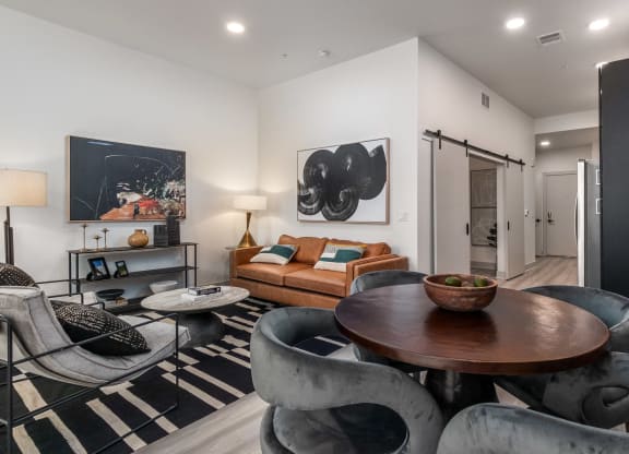 a living room with couches and chairs and a table