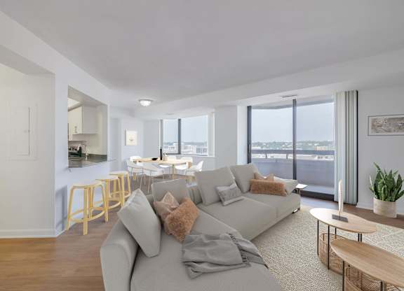 a living room with a couch and a table with chairs