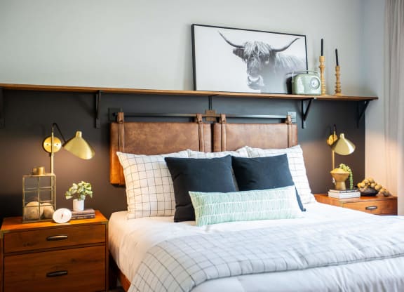 a bedroom with a bed and a painting of a bull