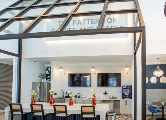 the kitchen and dining area of a glass house