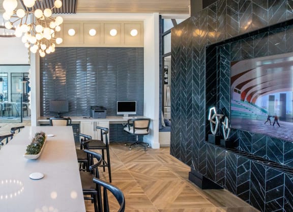 a conference room with a large tv and a table with chairs