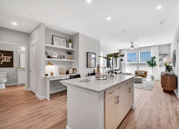the kitchen is open to the living room and dining room