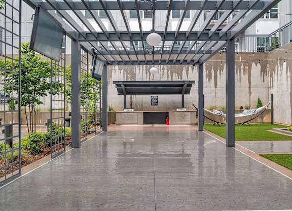 the lobby of a building with a pool and a hammock