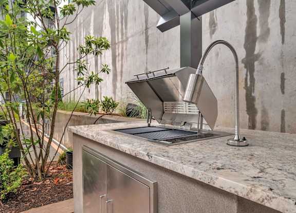 a kitchen counter with a sink and a faucet