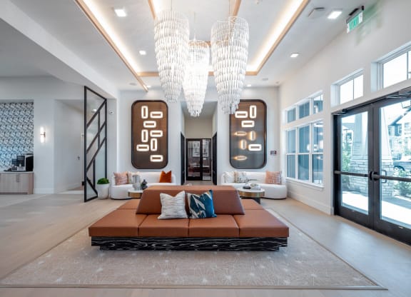 a living room with a couch and chandeliers