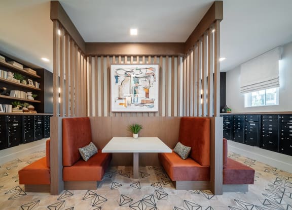a conference room with two orange couches and a white table