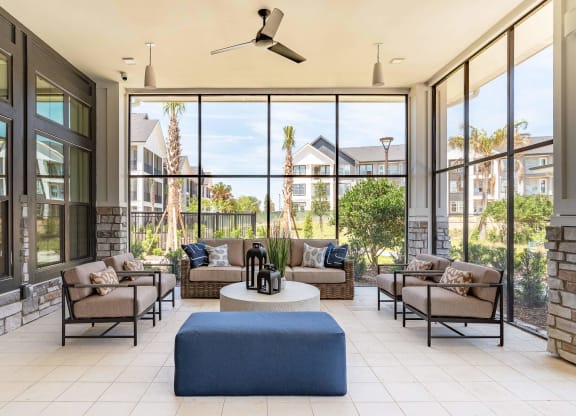 a living room with furniture and large windows