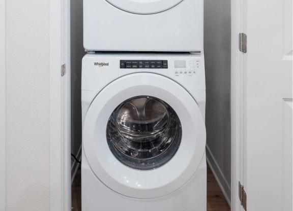 a white washer and dryer in a small laundry room