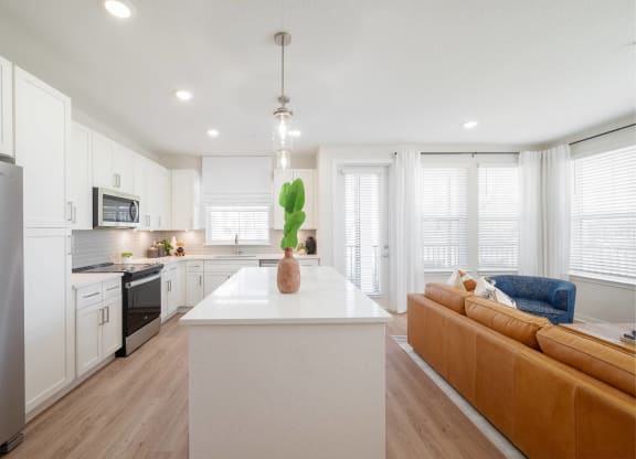 a kitchen with white cabinets and a white counter top
