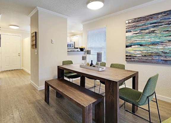 Dining area with wood table and green chairs at Hidden River Townhomes Apartments, Kirkland, WA