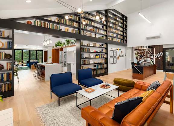 Open concept living space with floor to ceiling bookshelves at Scout Apartments, Kirkland, WA