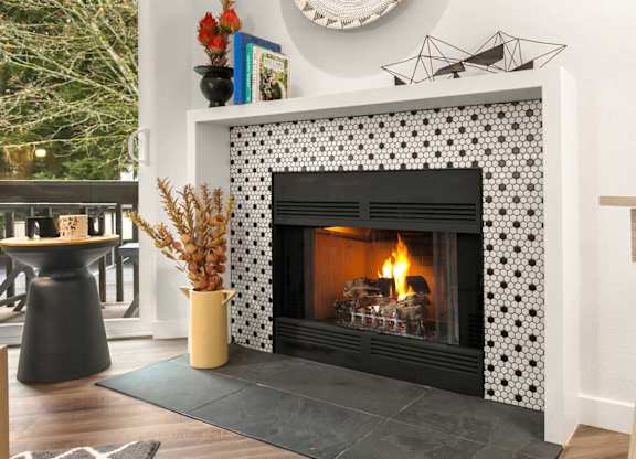 Living room with tiled fireplace and modern decor at Scout Apartments, Kirkland