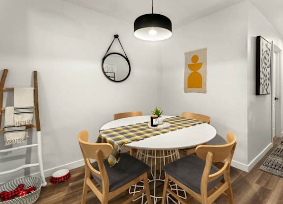 Dining area with round table and wooden chairs at Scout Apartments, Washington, 98034