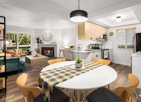 Open concept dining area and kitchen with fireplace at Scout Apartments, Kirkland, WA 98034